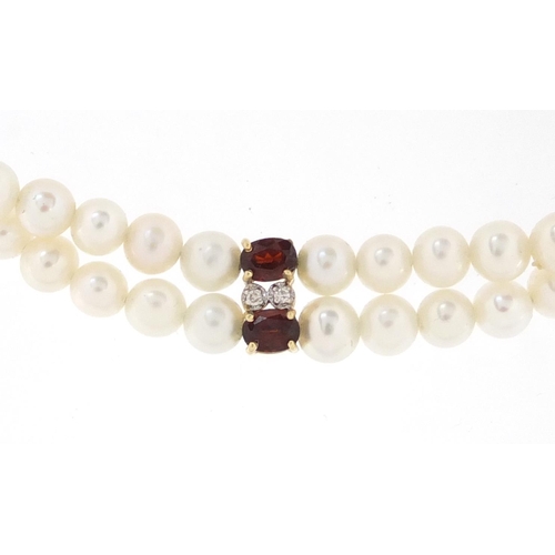 2885 - Two row pearl, garnet and diamond bracelet with 14ct gold clasp, 17cm in length, approximate weight ... 