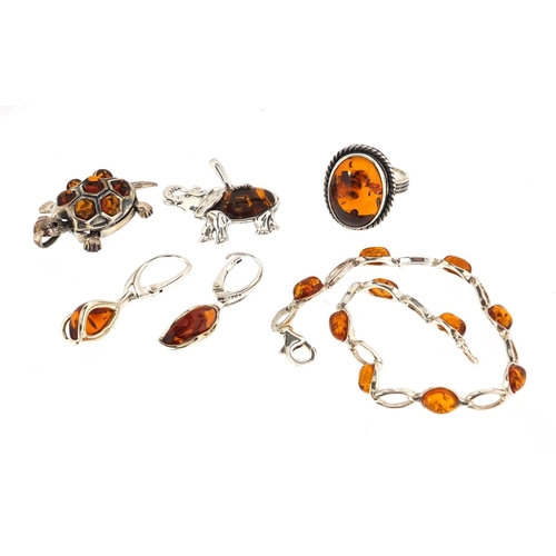 3012 - Silver and amber jewellery comprising ring, bracelet, elephant and tortoise pendants and a pair of e... 