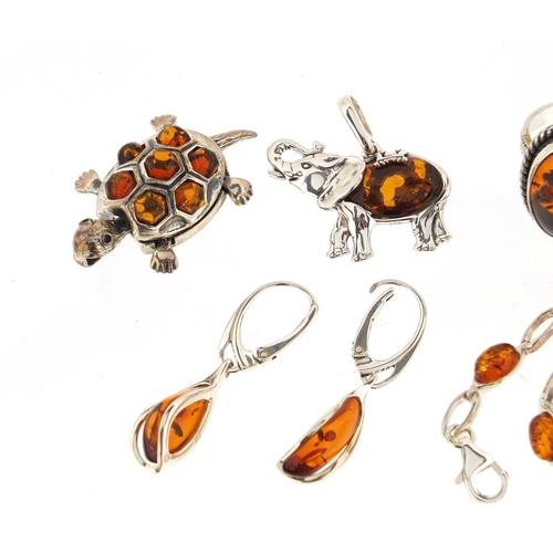 3012 - Silver and amber jewellery comprising ring, bracelet, elephant and tortoise pendants and a pair of e... 