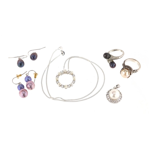 3020 - Silver and pearl jewellery comprising two rings, two pairs of earrings and two pendants, approximate... 