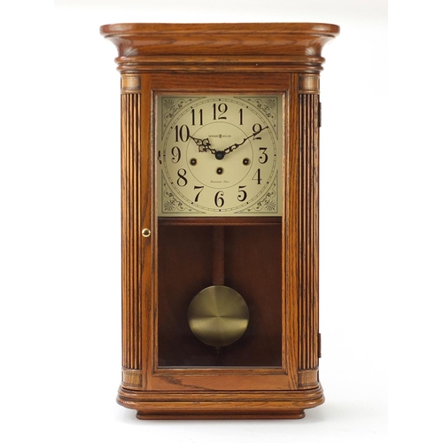 2145 - Howard Miller oak cased wall clock with Westminster chime, the dial with Arabic numerals, 61cm high