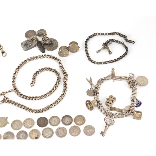 3031 - Silver and white metal jewellery including charm bracelets, watch chains and coins, approximate weig... 