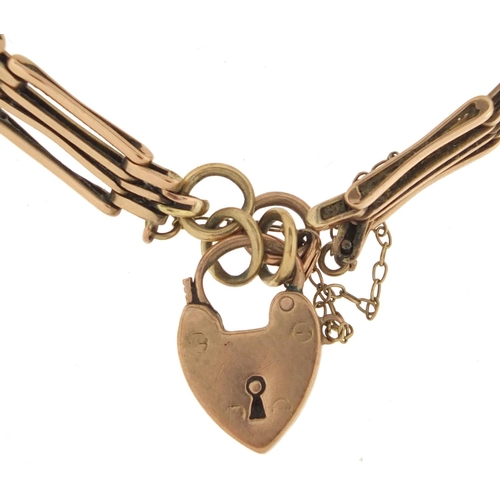2905 - 9ct gold four row gate bracelet with love heart shaped padlock, 16cm in length, approximate weight 1... 