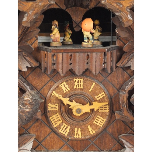 2171 - German Black Forest cuckoo clock with Roman numerals by Regula, carved with birds, foliage and berri... 