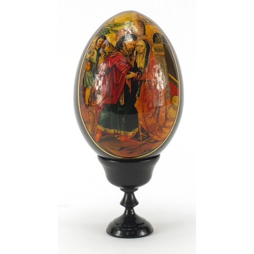2824 - Large Russian papier-mâché egg on stand hand painted with figures, signed and dated 1993 to the base... 
