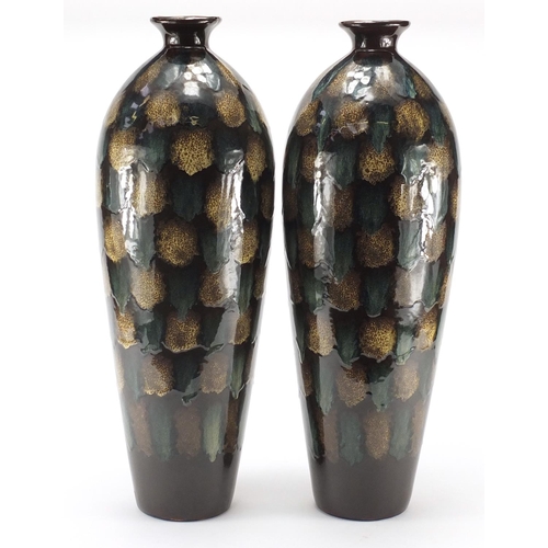 2463 - Pair of large pottery vases having a dripping glaze, each 55.5cm high