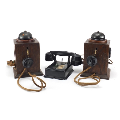 2362 - Two vintage Military interest oak telephones and a black Bakelite example, the largest 24.5cm high