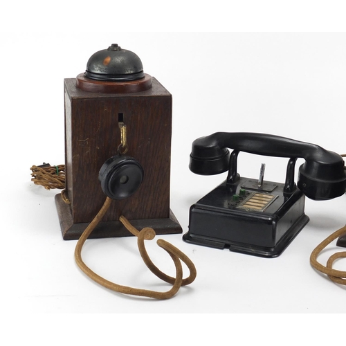 2362 - Two vintage Military interest oak telephones and a black Bakelite example, the largest 24.5cm high