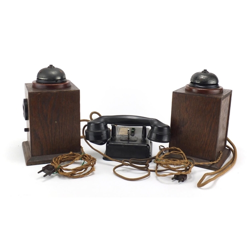 2362 - Two vintage Military interest oak telephones and a black Bakelite example, the largest 24.5cm high