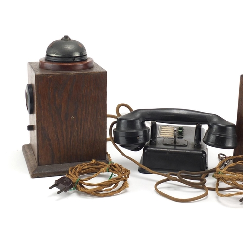 2362 - Two vintage Military interest oak telephones and a black Bakelite example, the largest 24.5cm high