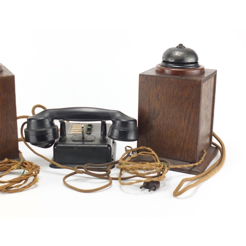 2362 - Two vintage Military interest oak telephones and a black Bakelite example, the largest 24.5cm high