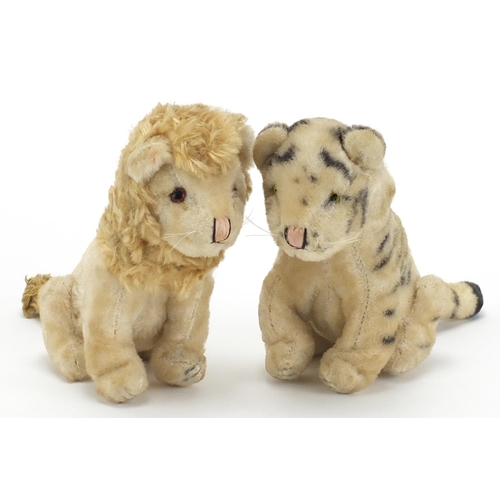 2649 - Two vintage stuffed animals possibly by Steiff comprising a tiger and lion, each 21.5cm in length