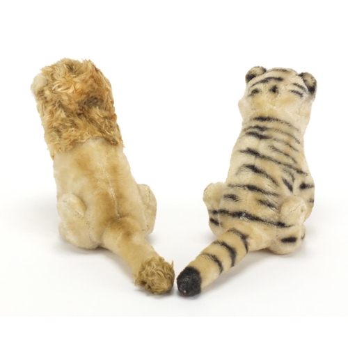2649 - Two vintage stuffed animals possibly by Steiff comprising a tiger and lion, each 21.5cm in length