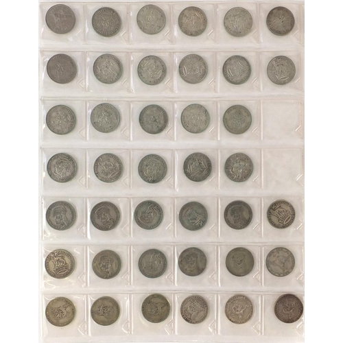 2807 - British coinage some pre 1947, mostly arranged in and album including shillings, two shillings, flor... 