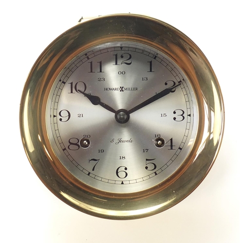 2396 - Howard Miller brass bulk head clock striking on a bell with Arabic numerals, 13.5cm in diameter