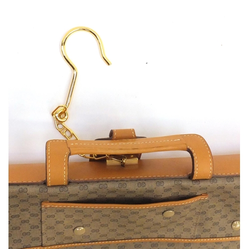 2693 - Gucci monogramed suit carrier with tag, 51cm wide
