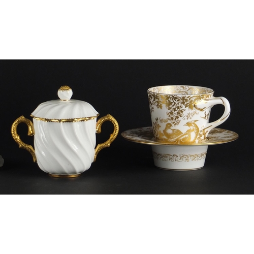 2293 - Cream and gilt porcelain comprising a Royal Crown Derby gold Aves Tasse Tremblant, Coalport cup and ... 