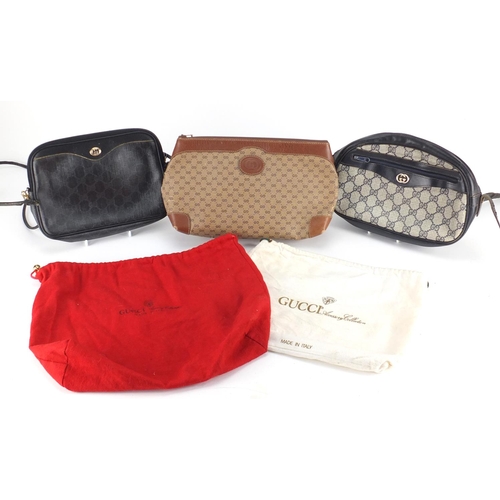 2696 - Two vintage Gucci monogrammed handbags and a wash bag, two with dust bags, the largest 31cm wide
