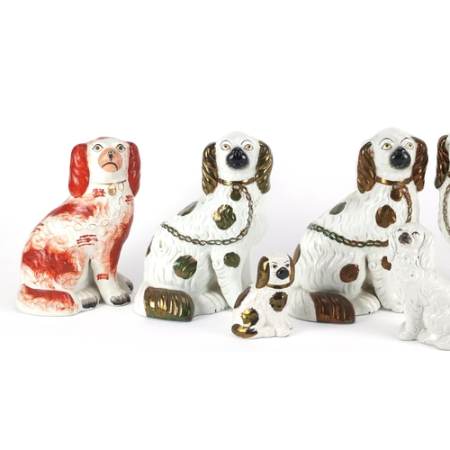 2453 - Two pairs of Staffordshire pottery seated spaniels and two others, the largest 23cm high