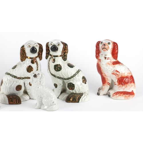 2453 - Two pairs of Staffordshire pottery seated spaniels and two others, the largest 23cm high