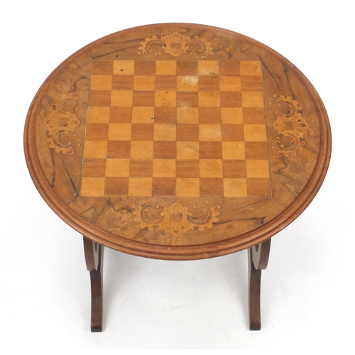 2097 - Walnut chess table with lyre supports, 46cm high x 50cm in diameter