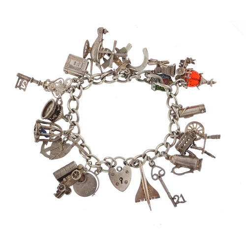 3016 - Silver charm bracelet with a selection of mostly silver charms including Concorde, bird in a cage, c... 
