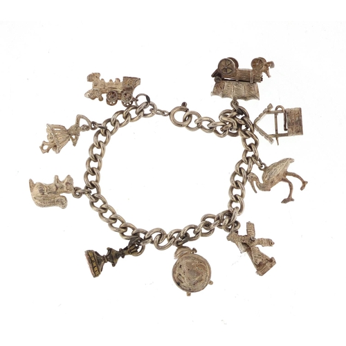 3014 - White metal charm bracelet with a selection of silver and white metal charms including a windmill, w... 