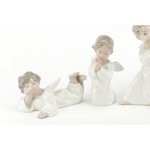 2624 - Four Lladro cherub figures, the largest 16cm high