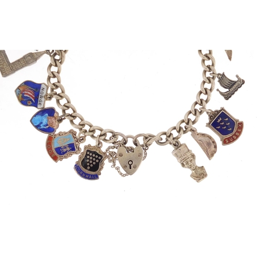 3075 - Silver charm bracelet with a selection of mostly silver charms, including some enamelled, approximat... 
