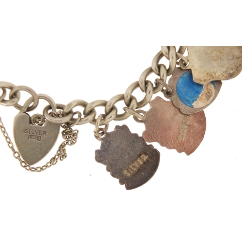 3075 - Silver charm bracelet with a selection of mostly silver charms, including some enamelled, approximat... 