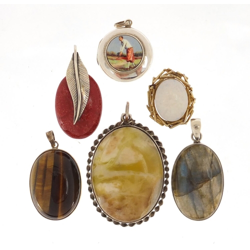 3074 - Silver pendants set with semi precious and a circular silver locket enamelled with a golfer, 5cm in ... 