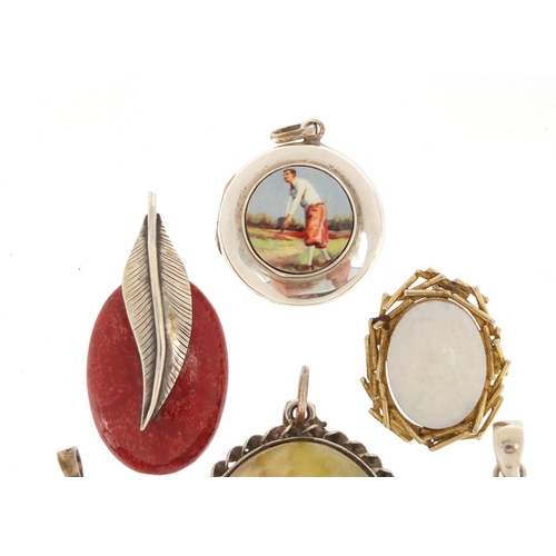 3074 - Silver pendants set with semi precious and a circular silver locket enamelled with a golfer, 5cm in ... 