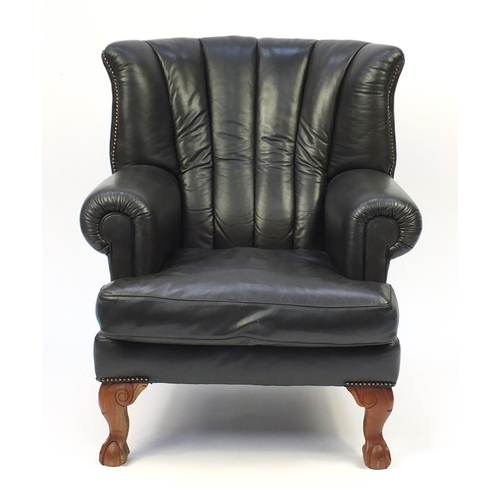 2002 - Dark green leather wing back armchair, 99cm high