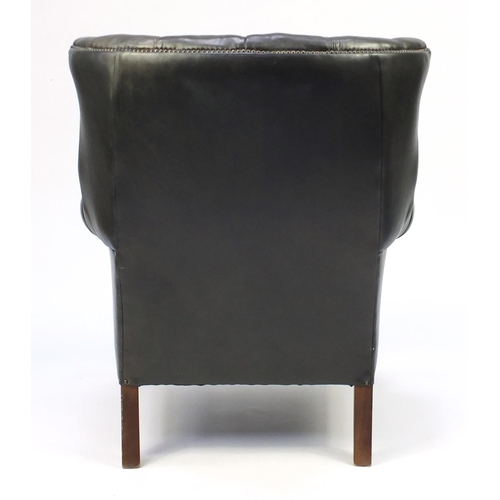 2002 - Dark green leather wing back armchair, 99cm high