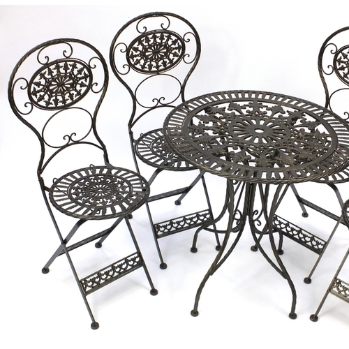 2030 - Gold painted wrought iron garden table with four folding chairs, the table 73cm high x 70cm in diame... 