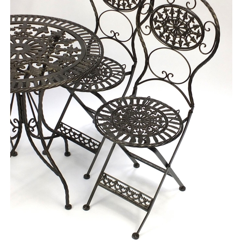 2030 - Gold painted wrought iron garden table with four folding chairs, the table 73cm high x 70cm in diame... 