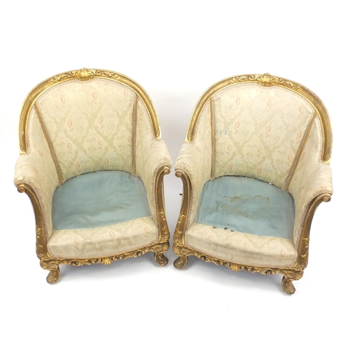 2096 - Pair of French gilt wood tub chairs, with scroll arms, shell carved knees and floral upholstery, 81c... 