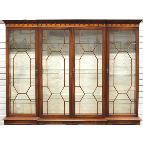 2013 - Mahogany breakfront bookcase, fitted with four astragal glazed doors each enclosing three adjustable... 