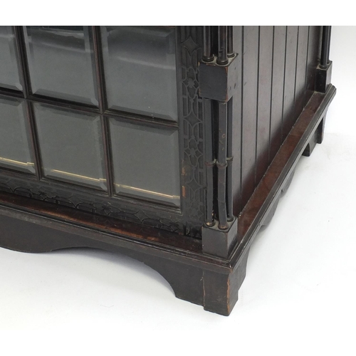 2001 - Chinese Chippendale design bookcase on stand with swan neck pediment, above a pair of glazed doors e... 