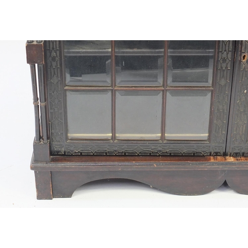 2001 - Chinese Chippendale design bookcase on stand with swan neck pediment, above a pair of glazed doors e... 