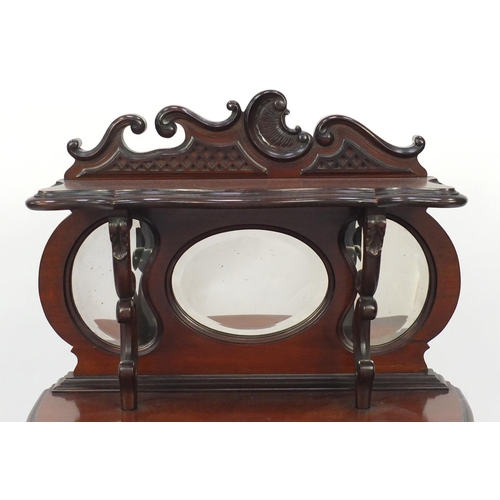 2081 - Edwardian mahogany pier cabinet with mirrored back above a pair of glazed doors, raised on cabriole ... 