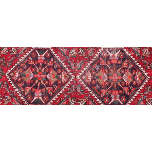 2094 - Rectangular Persian Caucasian design carpet runner, having stylised floral panels onto a red ground,... 