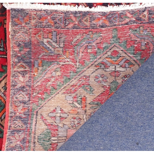 2094 - Rectangular Persian Caucasian design carpet runner, having stylised floral panels onto a red ground,... 