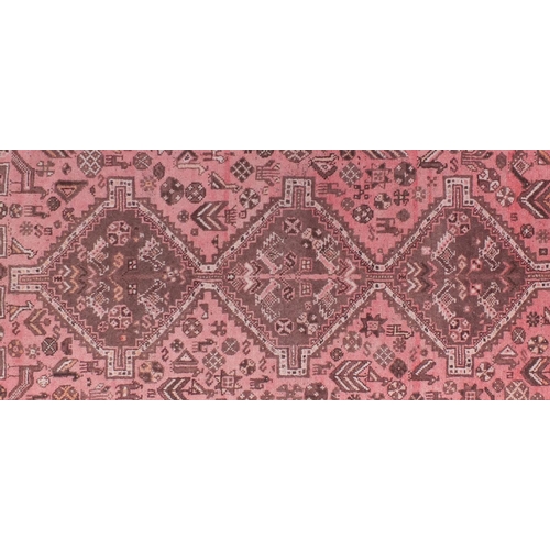 2149 - Rectangular Persian Shiraz salmon ground rug, decpicting with camels and birds, 195cm x 164cm