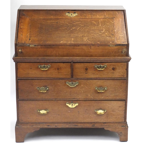2048 - Georgian oak bureau, the fall enclosing a fitted interior and well, above four drawers, 100cm H x 85... 