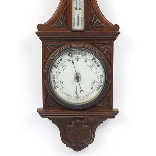 2247 - Oak aneroid barometer carved with a shield, 90cm high