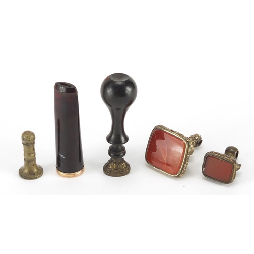693 - Unmarked gold mounted amber coloured cheroot together with four seals including two gilt metal examp... 