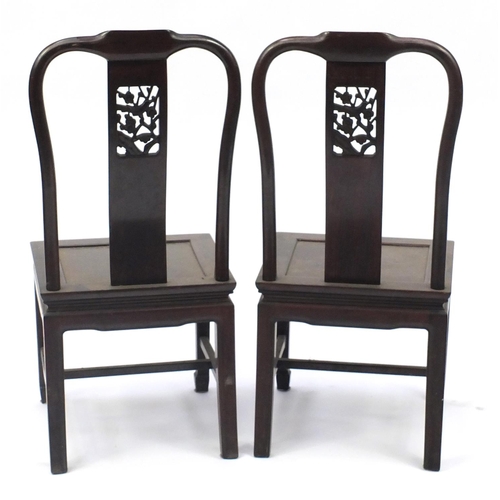 12 - Pair of Chinese hardwood chairs, the backs carved with a bird amongst flowers, 97cm high