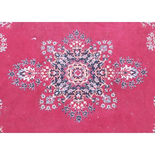 26 - Red and cream ground floral patterned rug, 325cm x 240cm