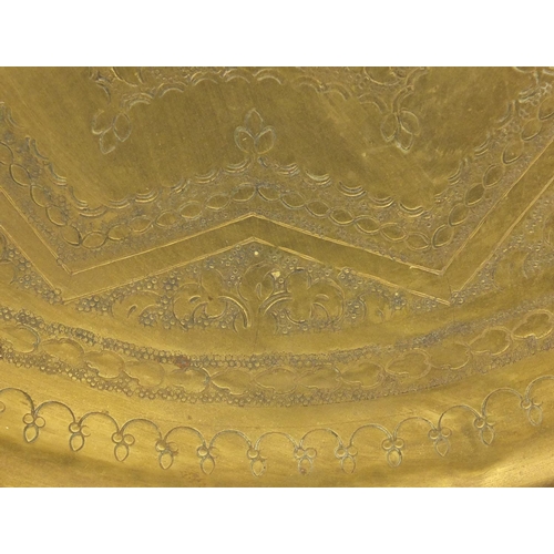 826 - Large circular brass Middle Eastern tray engraved with star and floral motifs, 76cm in diameter